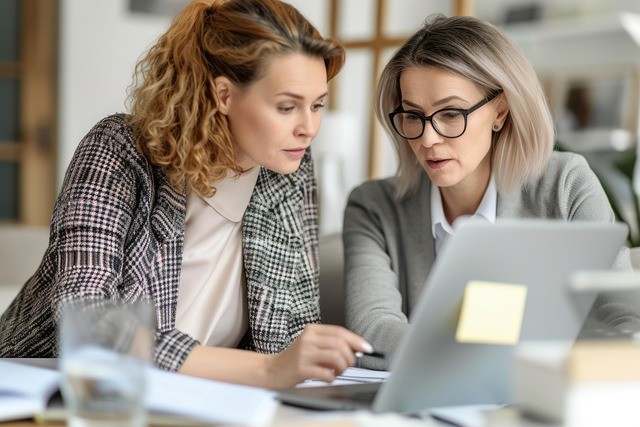 Two ladies discussing documents